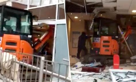 man goes in building with mini excavator|Disgruntled Unpaid Worker Destroys New Travelodge Hotel.